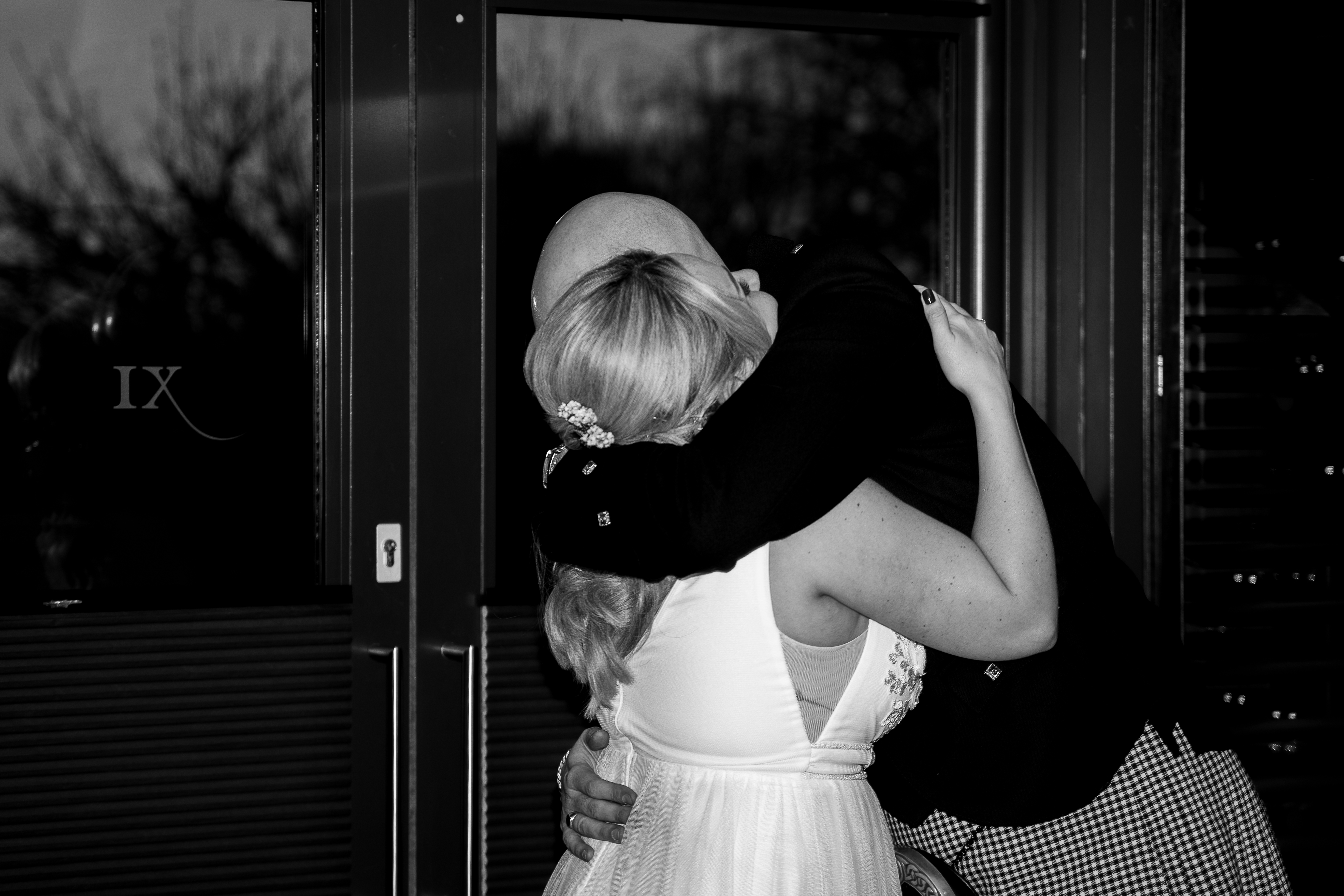 couple hugging tightly in black and white image bride and groom